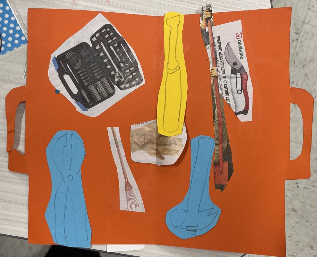 Construction paper tool box with cut outs of tools.