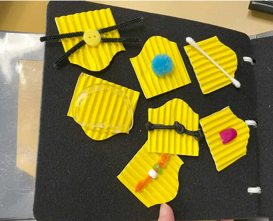 Tactile object symbols to in a small felt binder. 