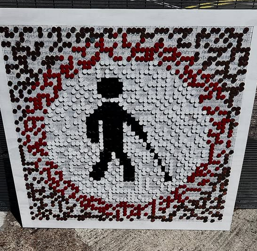 Art piece that is tactile showing a shadow of a person walking with a cane.