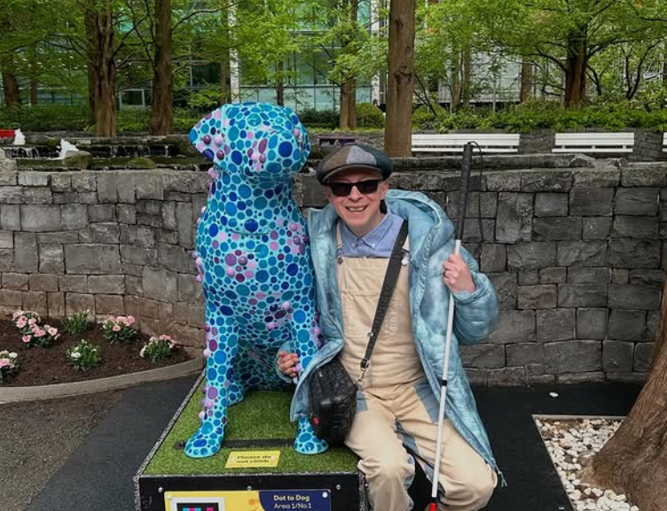 Mr. Dot and an art piece that is a large 3D image of a dog with his dots.