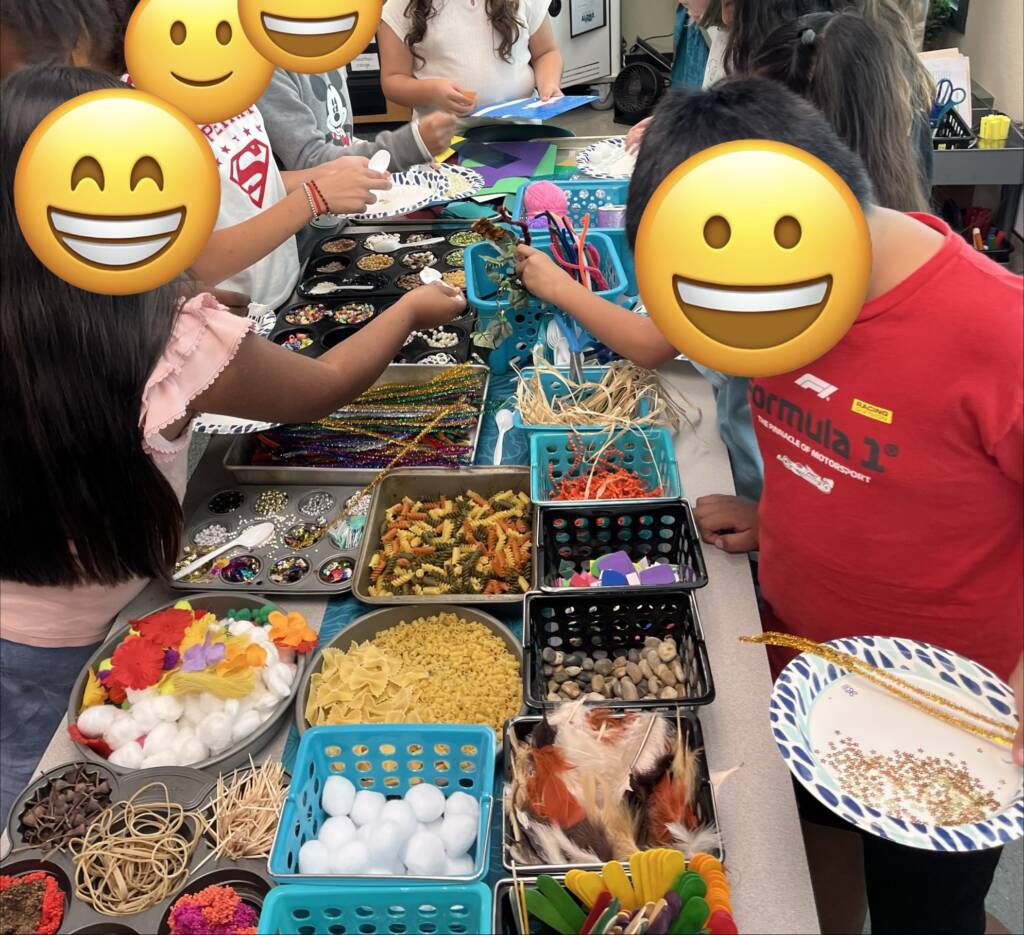 Group of students holding their paper plates and  “shopping” the supplies.