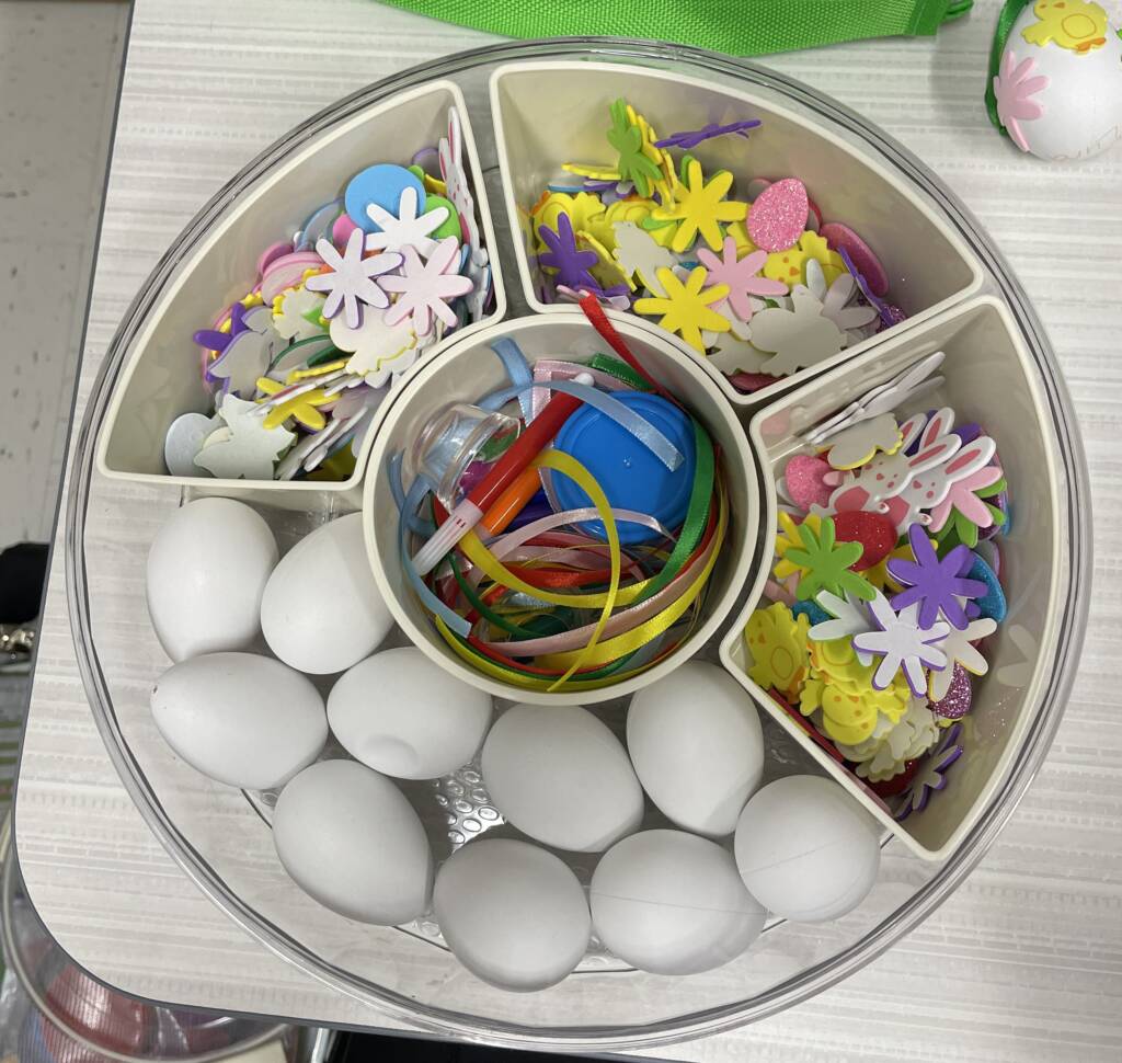 Divided tray with eggs, foam stickers, ribbons and markers in each section. 