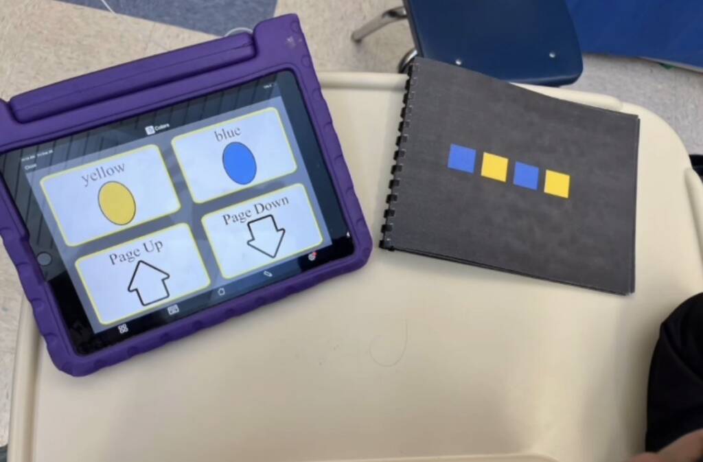 A blue, yellow, blue, yellow pattern on paper and an AAC device with blue, yellow for choice making. 