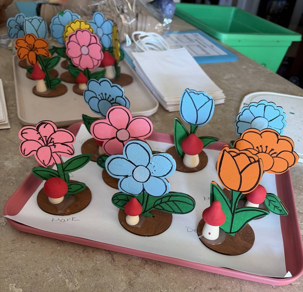 Finished wooden flowers all painted and drying on a tray.