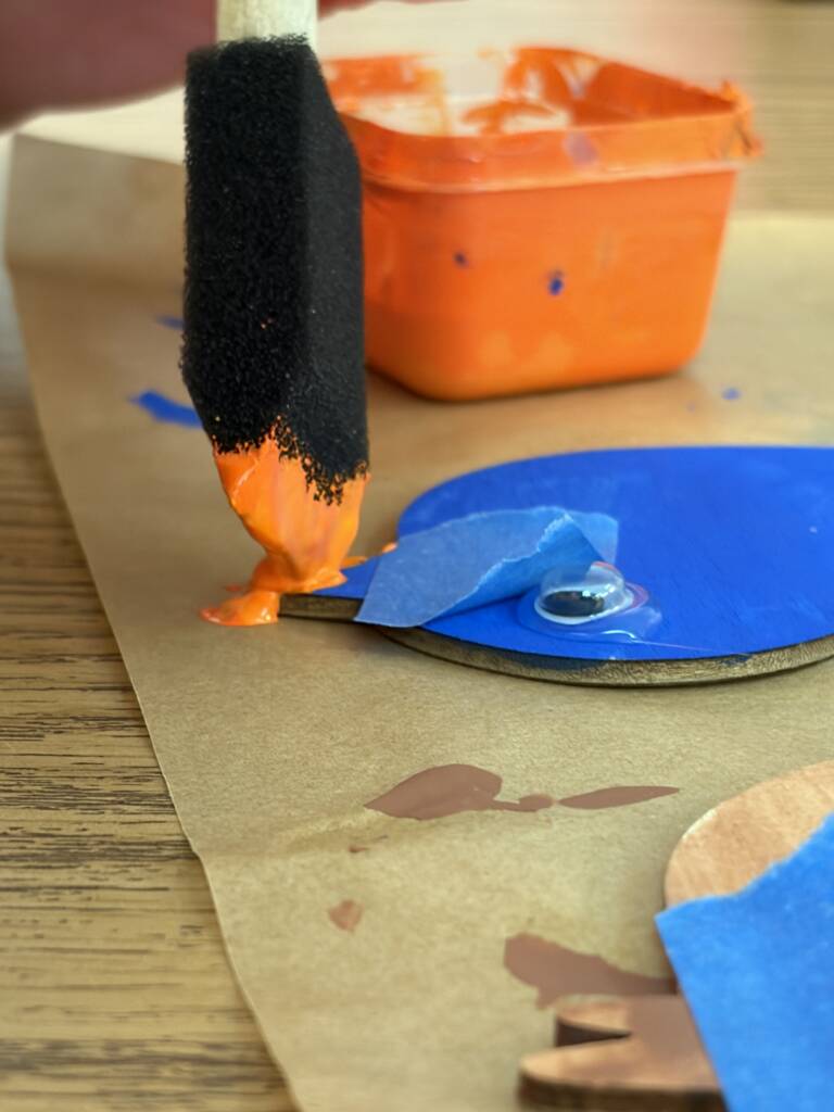 Painting the beak of the bird. 