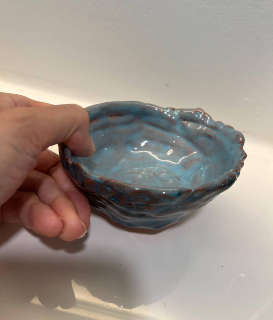 Hand size coil pinch pot.