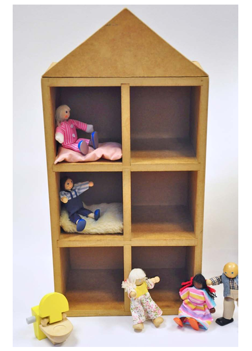 Wooden braille doll house that has six rooms, 2 on each floor that is like a braille cell.