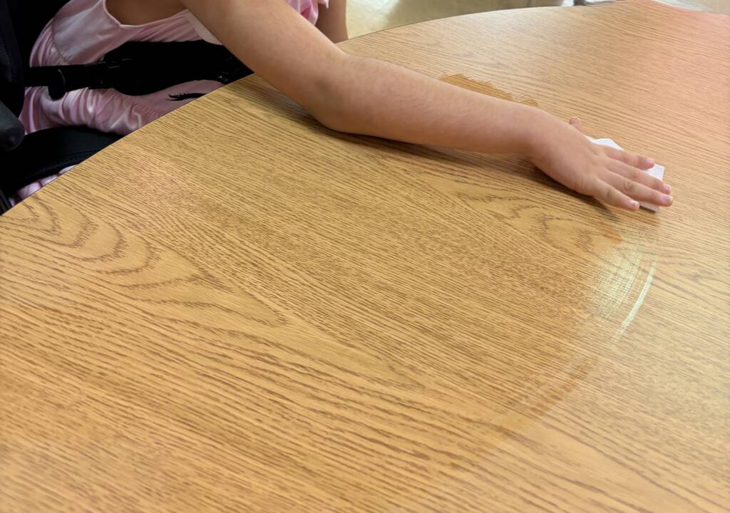 Student cleaning up her area.