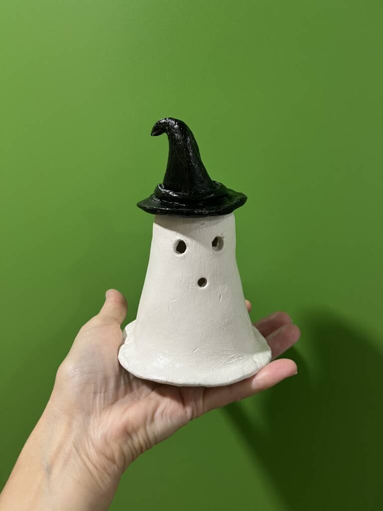 A ceramic ghost with a witch hat.