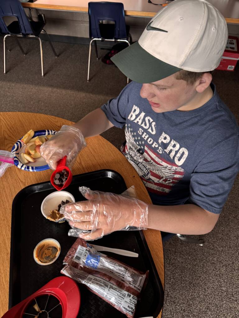 Liam mixing the ingredients with his gloves on. 