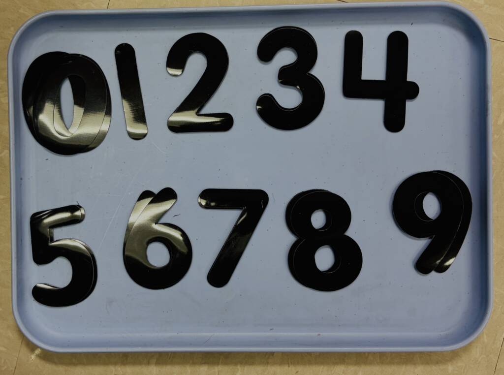 A tray of the solid black numbers 0-9.