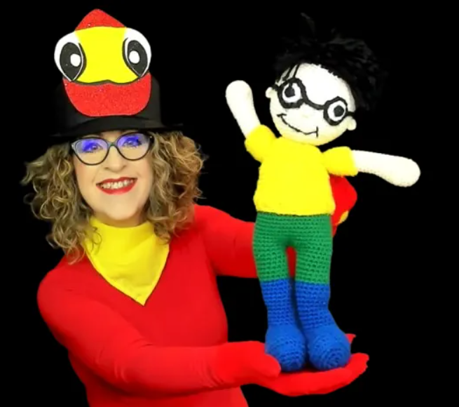 Gwen with the puppet Marvin in high contrast colors with a black background.